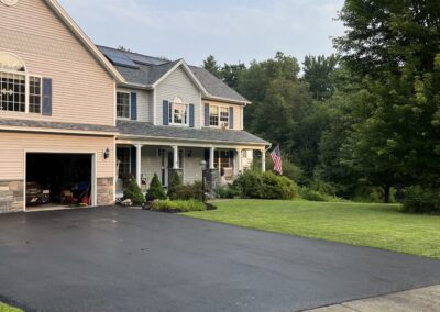 Home with freshly paved driveway