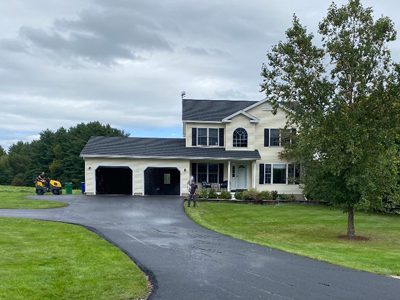 Paved driveway in front of two garage house